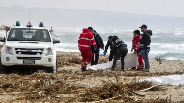 Rescuers recover a body after a suspected migrant boat is wrecked and bodies believed to be of refugees were found in Cutro, the eastern coast of Italy's Calabria region, Italy, on 26 February 2023