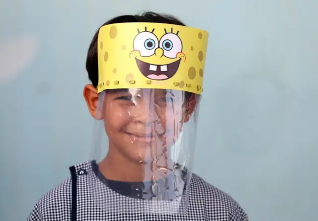 A Tunisian child wears a face shield in a school in Tunis. It features cartoon character Spongebob Squarepants.