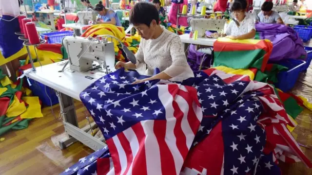 Chinese employees sew US flags at a factory in Fuyang