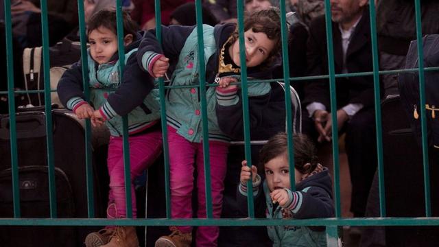 Niños esperan en el cruce fronterizo de Rafah, entre Gaza y Egipto
