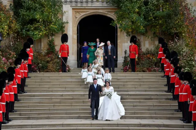 Princess Eugenie of York and her husband Jack Brooksbank walk down the West Steps of St Georg's Chapel
