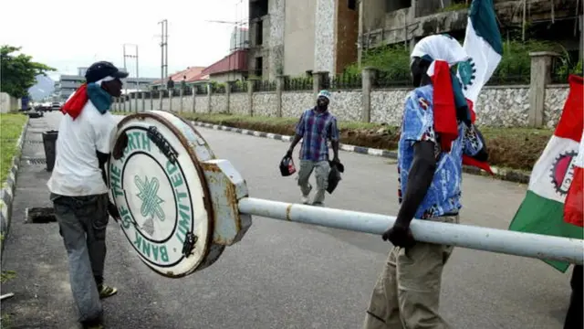 Striking workers removing a barricade in Nigeria
