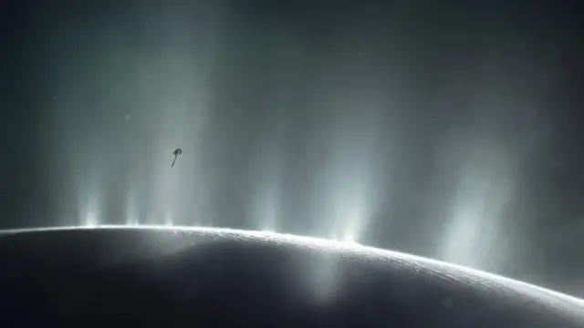 Ilustração simula visita da Cassini a Enceladus, uma das luascaça níquel dóiSaturno.