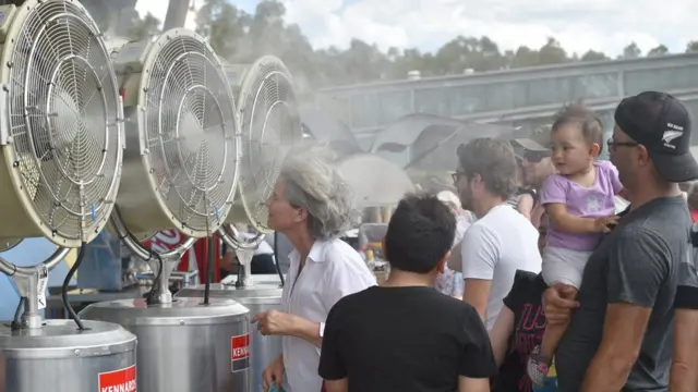 Espectadoresbetpix365 modernatênis se refrescaram com um ventilador durante jogo