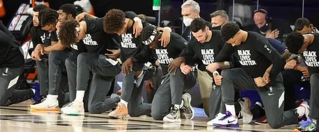 Utah Jazz and New Orleans Pelicans players kneel before their game