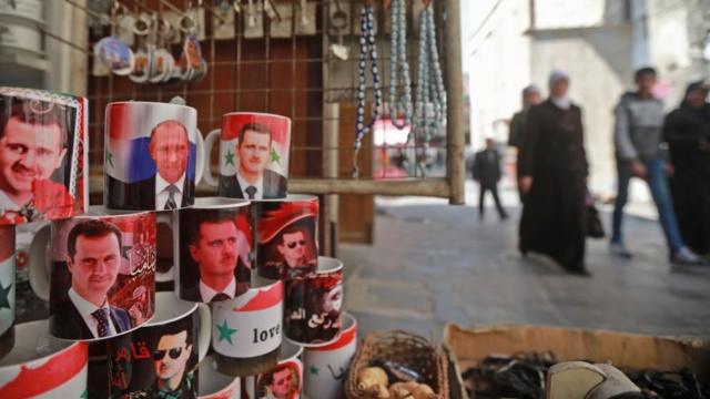 Mugs bearing the portraits of Syrian President Bashar al-Assad and Russian President Vladimir Putin are sold in the old Syrian city of Damascus on March 12, 2019. (Photo by LOUAI BESHARA / AFP) (Photo credit should read LOUAI BESHARA/AFP/Getty Images)