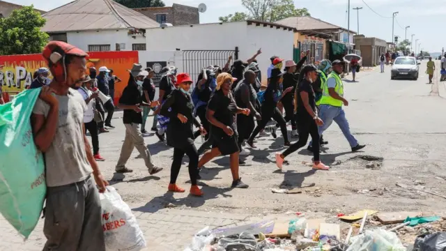 Disgruntled South African job seekers belonging to Alexandra Dudula Movement march in the township streets during their operation to remove foreign street vendors on pavements and stalls in Alexandra township in Johannesburg on February 13, 2022.