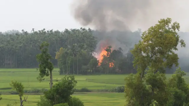 Smoke rises from what is believed to be a burning village in the southern Maungdaw area of Myanmar's Rakhine state on September 4, 2017. Nobel peace laureate Malala Yousafzai and Muslim countries in Asia led a growing chorus of criticism on September 4 aimed at Myanmar and its civilian leader Aung San Suu Kyi over the plight of its Rohingya Muslim minority. / AFP PHOTO / STR (Photo credit should read STR/AFP/Getty Images)