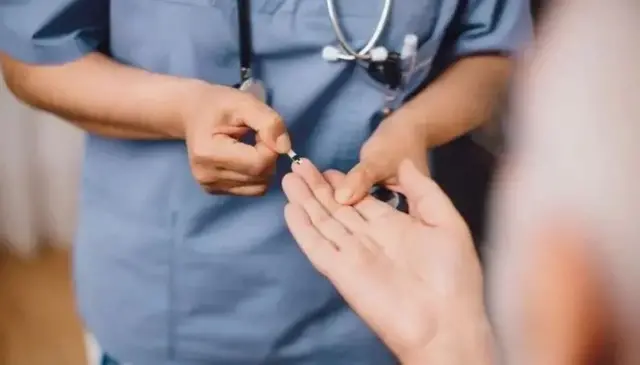 د ډاکټر او ناروغ لاسونه ښکاري چې د شکرې ناروغۍ معاینې لپاره یې وینه اخلي