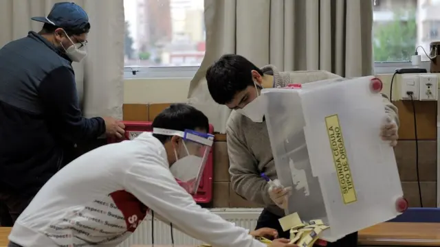 Election officials count ballots after polls closed at a school used as a polling station during a referendum on a new Chilean constitution in Concepcion, Chile, October 25, 2020