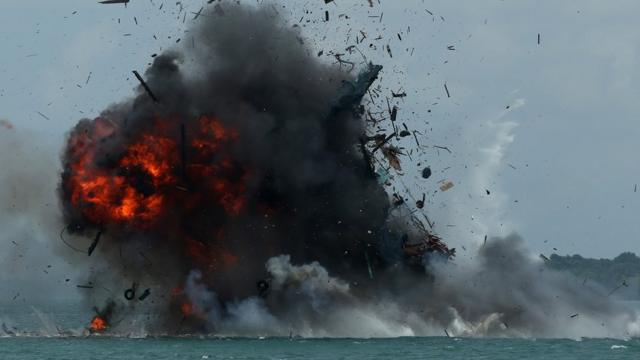 One of seven fishing boats is blown up by the Indonesian government in Batam, Kepulauan Riau province on February 22, 2016. Indonesia sank 27 impounded foreign boats on February 22, a minister said, as the world's largest archipelago nation stepped up a campaign against illegal fishing in its waters.