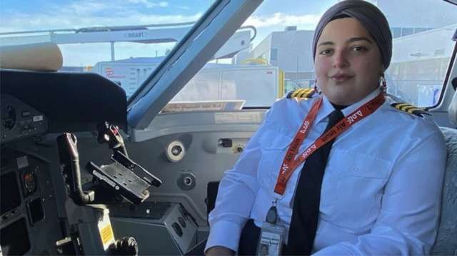 Nour Utayim posing inside a plane