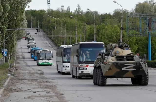 Buses carrying service members of Ukrainian forces who have surrendered after weeks holed up at Azovstal steel works drive away under escort of the pro-Russian military in the course of Ukraine-Russia conflict in Mariupol, Ukraine May 17, 2022.