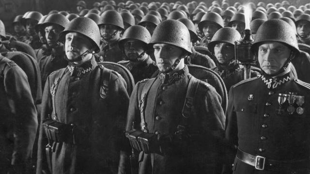 circa 1939: A Polish infantry regiment standing to attention during a parade at night. (Photo by Fox Photos/Getty Images)