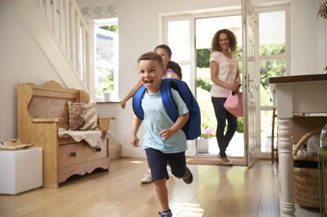 Madre e hijos entrando a su casa.