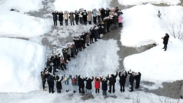Children and staff at a hospice spelling out "Z" in the open air