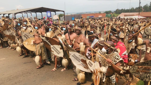 Zulu men wear traditional warrior outfits for night for Nongoma, South Africa - March 2021
