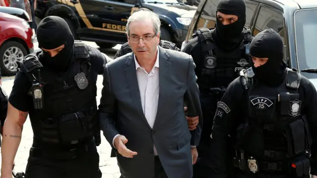 Eduardo Cunha sendo escoltado por policiais