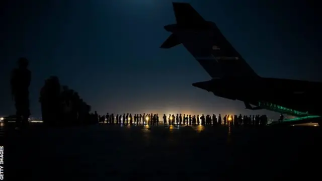 An air crew prepares to load evacuees at Kabul airport in August 2021