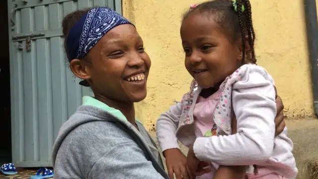 መሠረት ልጇን ታቅፋ