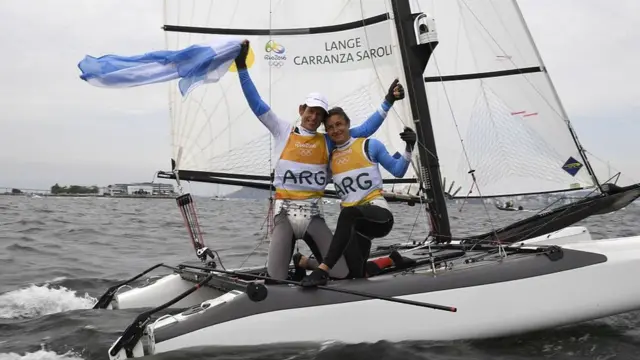 Los argentinos Santiago Lange y Cecilia Carranza Saroli celebran tras ganar la carrera de medallas mixtas Nacra 17 en Marina da Gloria durante los Juegos Olímpicos Río 2016.