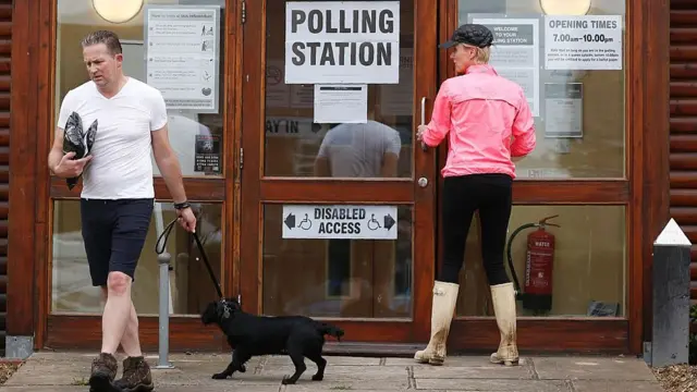 Voter entering and another leaving a polling station