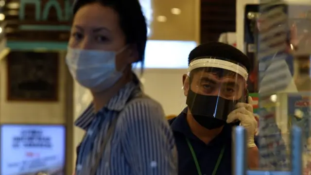 staff member and customer at Almaty pharmacy