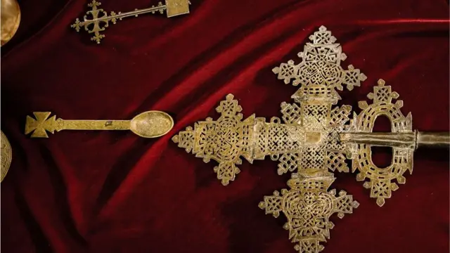 A golden cross laying on a red cloth at a museum in Addis Ababa, Ethiopia - Saturday 20 November 2021