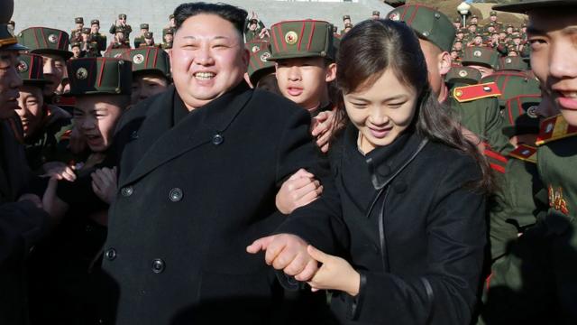 Supreme Leader Kim Jong-un and his wife are surrounded by young people in service wear