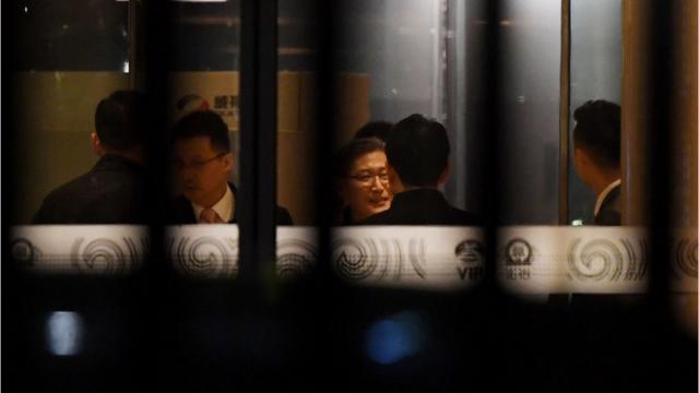 North Korean and Chinese officials gather at the VIP entrance at Beijing airport after the arrival of flight MH360 from Malaysia early on 31 March 2017.