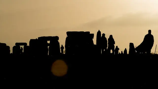 Druids, pagans and revellers gather at Stonehenge, hoping to see the sun rise