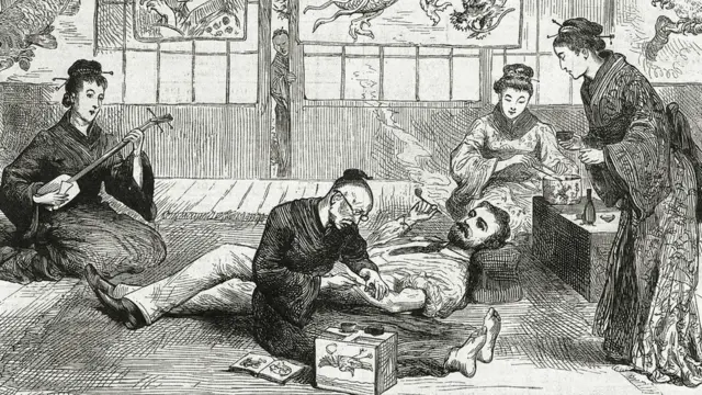 An artist tattoos a European visitor in Nagasaki, Japan in 1881 as geishas prepare tea (Credit: Pictorial Press Ltd/Alamy)