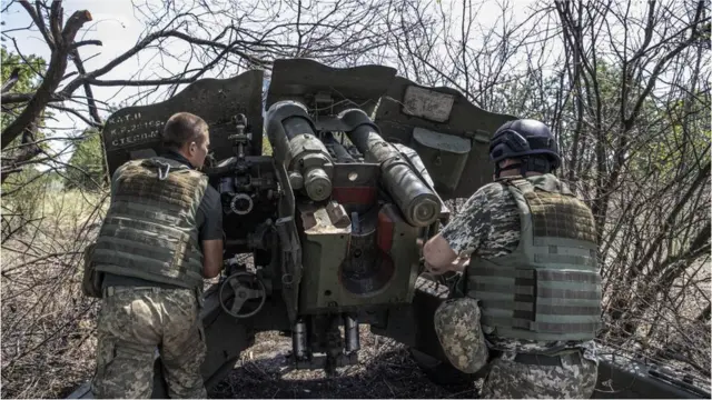 Ukrainian artillerymen check the weapons and special equipment to make them ready before they go to their duties at the frontline in Kherson, in July 2022