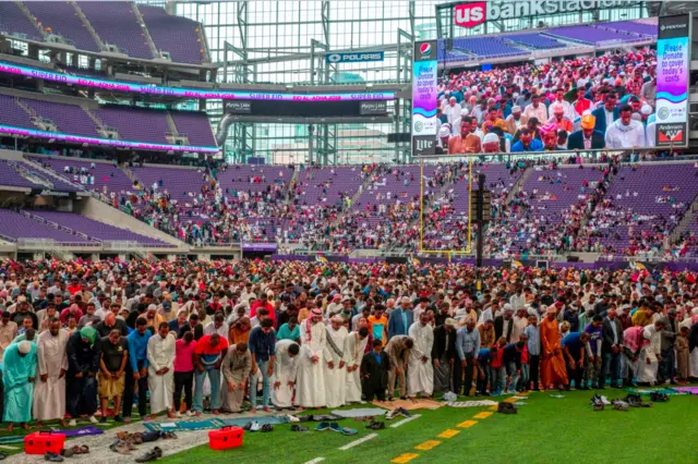 Muslim worshippers gather at the US Bank Stadium during Eid al-Adha prayers and festivities on August 21, 2018 in Minneapolis, Minnesota. - The US Bank Stadium, home of the National Football League's Minnesota Vikings, is hosting thousands for the event that organizers are calling Super Eid. The holiday, one of the holiest of the year for Muslims, honors the Prophet Ibrahim, also known as Abraham in Judaism and Christianity, and comes at the end of annual hajj pilgrimage.