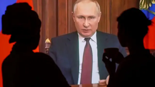 Russian people watch a special televised address by Russian President Vladimir Putin about authorising a special military operation in the Ukrainian Donbass region in Moscow, Russia, 24 February 2022.