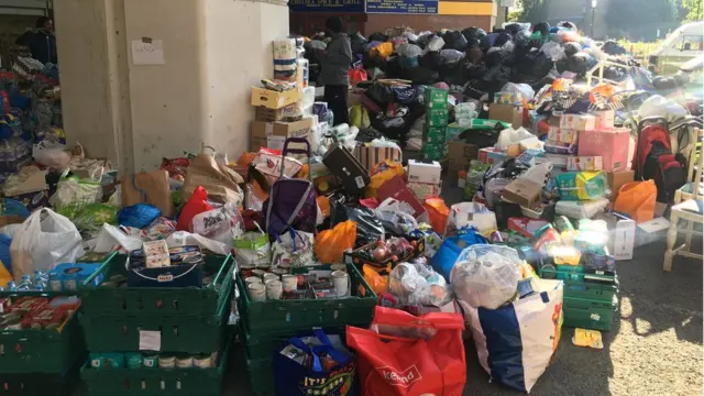 Piles of supplies donated to Grenfell Tower victims