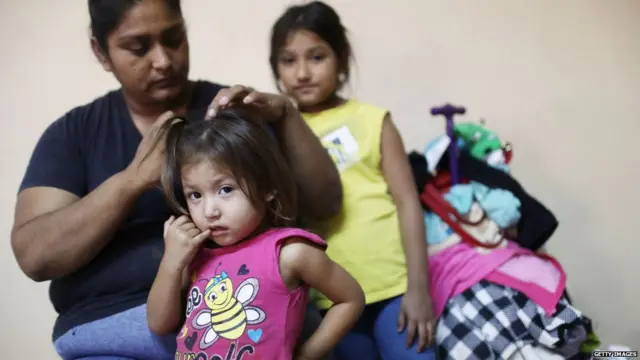 A migrant mother, who is waiting to seek asylum for herself and her two daughters in the U.s