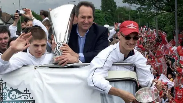 Gerard Houllier celebrates Liverpool's cup treble in 2001 on an open-top bus parade with Steven Gerrard and Sami Hyypia