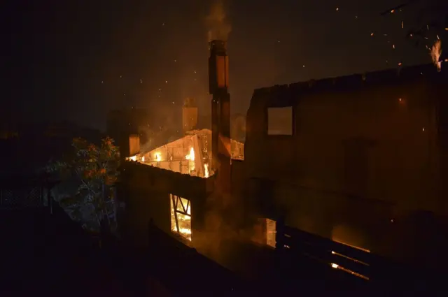 A house burns as a wildfire rages at the village of Mati, near Athens.