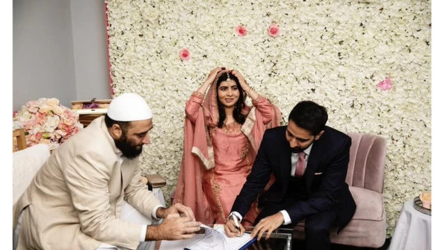 Malala ajuste son voile pendant qu'Asser Malik signe le certificat de mariage.