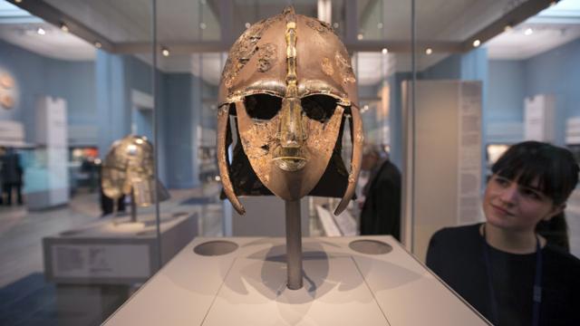 A woman views the Sutton Hoo Helmet on display in the new gallery 'Sutton Hoo and Europe AD 300-1100' in the British Museum