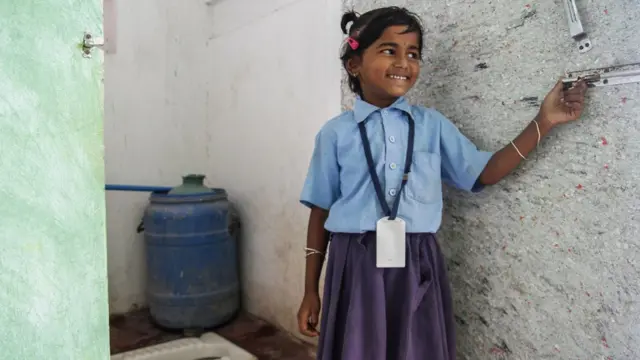 Uma menina na índia do ladoroulette 3dforaroulette 3dum banheiro com vaso instalado pela WaterAid