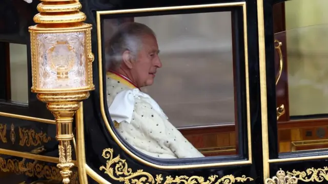 King Charles III inside carriage