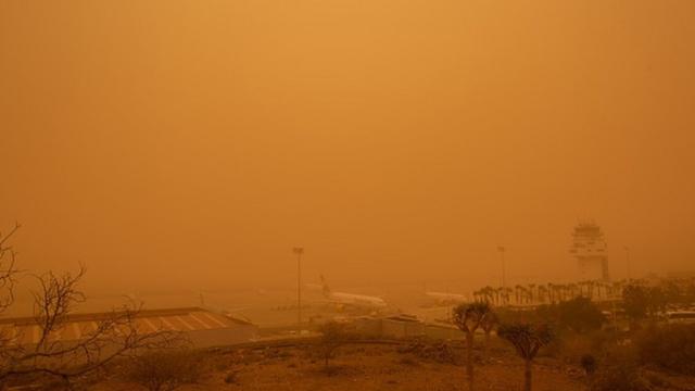 Planes are pictured at Tenerife South Reina Sofia Airport during a sandstorm