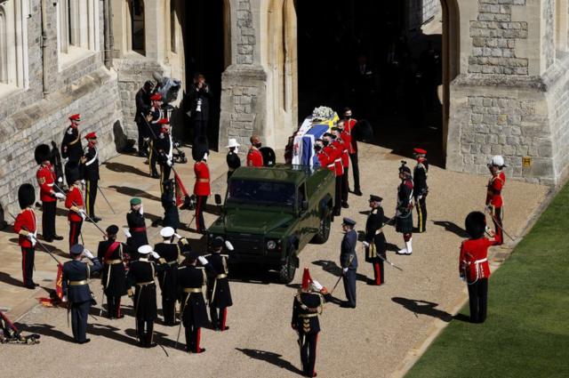 O caixão do duque de Edimburgo, coberto com o estandarte pessoal de Sua Alteza Real, é transportado para o Land Rover especialmente construído para o funeral do Príncipe Philip no Castelo de Windsor em 17 de abril de 2021