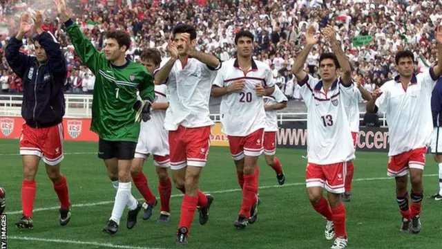 Iran players, wearing the USA shirts they have swapped, acknowledge the Rose Bowl crowd after their 1-1 draw