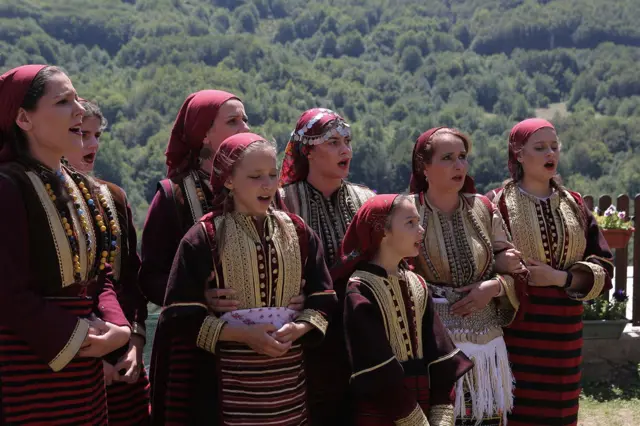 Dolazak svadbene kolone predvođene starim svatom u ulozi barjaktara, mladoženjom sa kumom te njegovom rodbinom i prijateljima u nevestin dom takođe nosi snažnu simboliku. Nakon postavljanja barjaka na kuću, čina prosidbe i predaje darova mladoj od strane svekrve, sve je spremno za njen odlazak iz roditeljske kuće: tom prilikom hor devojaka peva tužne pesme.