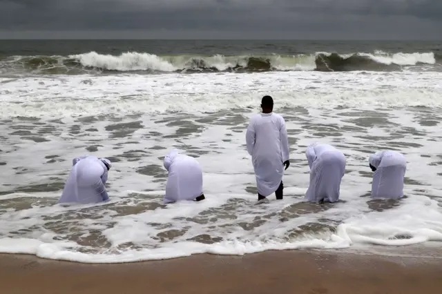 Members of the Celestial Church of Christ, popularly known as the white garment church, perform a spiritual prayer at the seashore of the Atlantic in Lagos, Nigeria, 01 September 2021. The white garment church members, as they are popularly known, go to the seashore as part of their religious practices for deliverance from terminal diseases and spiritual healings. It is an age-long spiritual practice believed to be unique and bible-based.