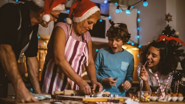 Grandparents making Gingerbread biscuits with their grandchildren for Christmas.