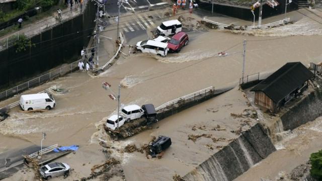 Roads are covered in mud waters after a landslide caused by heavy rains in Aki, Hiroshima prefecture